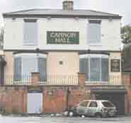 The Cannon Hall pub, with windows boarded over.