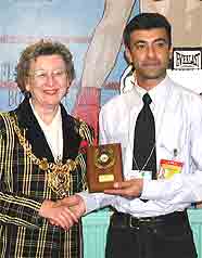 The Lord Mayor presents Islam Khan with his plaque.