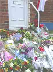 Flowers placed outside a door.