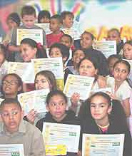 Children display their certificates.