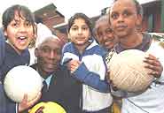 Uriah Rennie with young  football players.