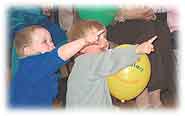 Young children enjoying entertainment at the SureStart re-launch.