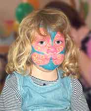 A young girl with a painted face.