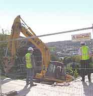 Workmen survey the demolition proceedings.