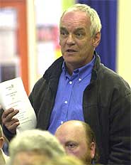 A resident at the public meeting makes his voice heard.