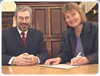 Bob Kerslake and Rose Ardron sign the agreement.