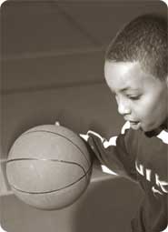 Young boy playing basketball.
