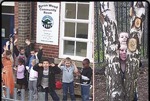 Children outside the Byron Wood Community Room. Two kids peek through the gap between two branches.