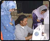 Adults on a sewing course.