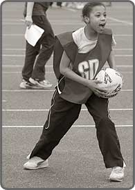 Girl playing netball.