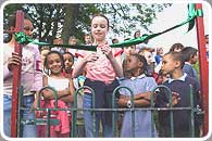 Rose Almond cuts the ribbon on one of the two gates to the refurbished Abbeyfield Park playground
