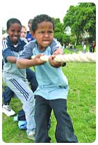Young boy playing tog of war.